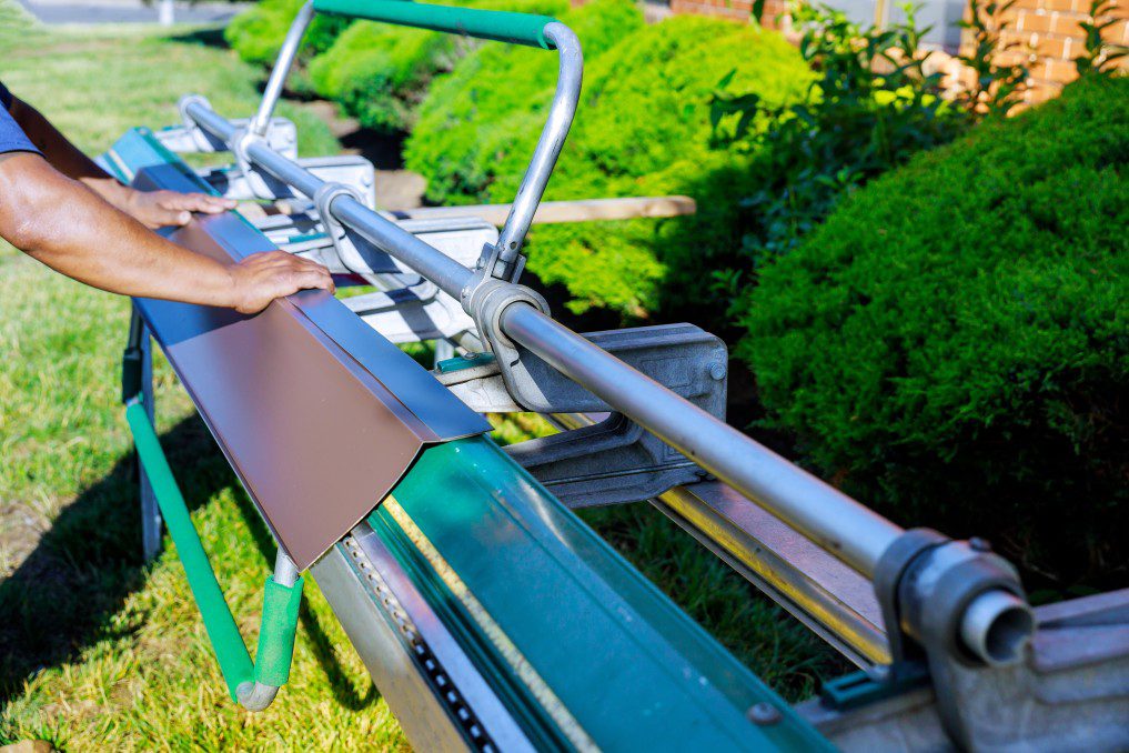 A professional preparing roof flashing for a roof