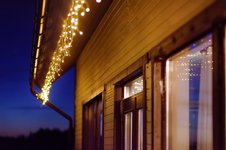 Lights hanging from the guttering of a house