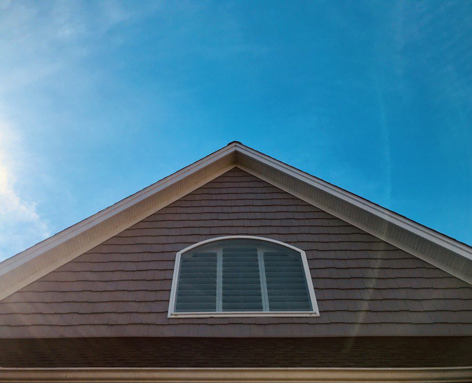 A gable roof edge with a blue sky background