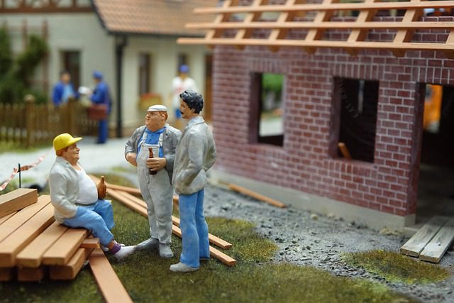 Model construction workers on new roof